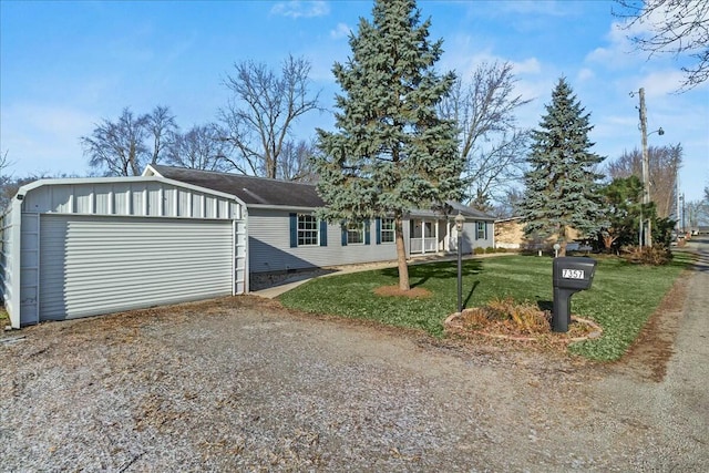 single story home featuring a front lawn and a garage