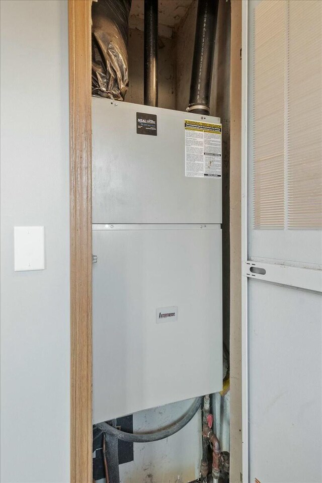 utility room featuring water heater