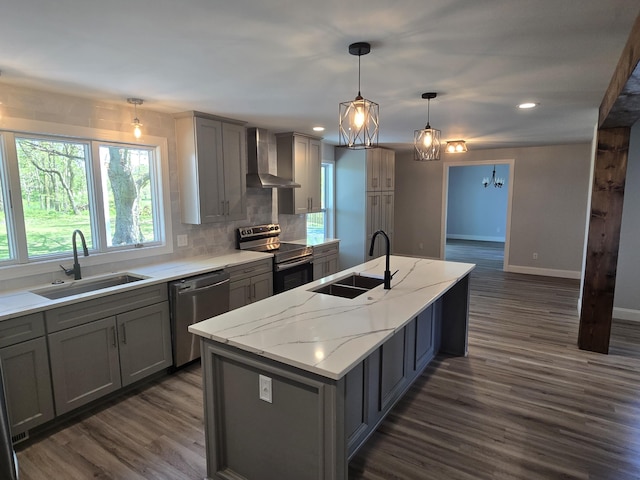 318 W Buckeye St, Belle Center, OH 43310 - kitchen featuring stainless steel appliances, wall chimney exhaust hood, gray cabinets, dark wood-type flooring, and a center island with sink