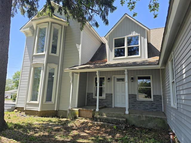 318 W Buckeye St, Belle Center, OH 43310 - view of front of property featuring board and batten siding, a porch, and a shingled roof