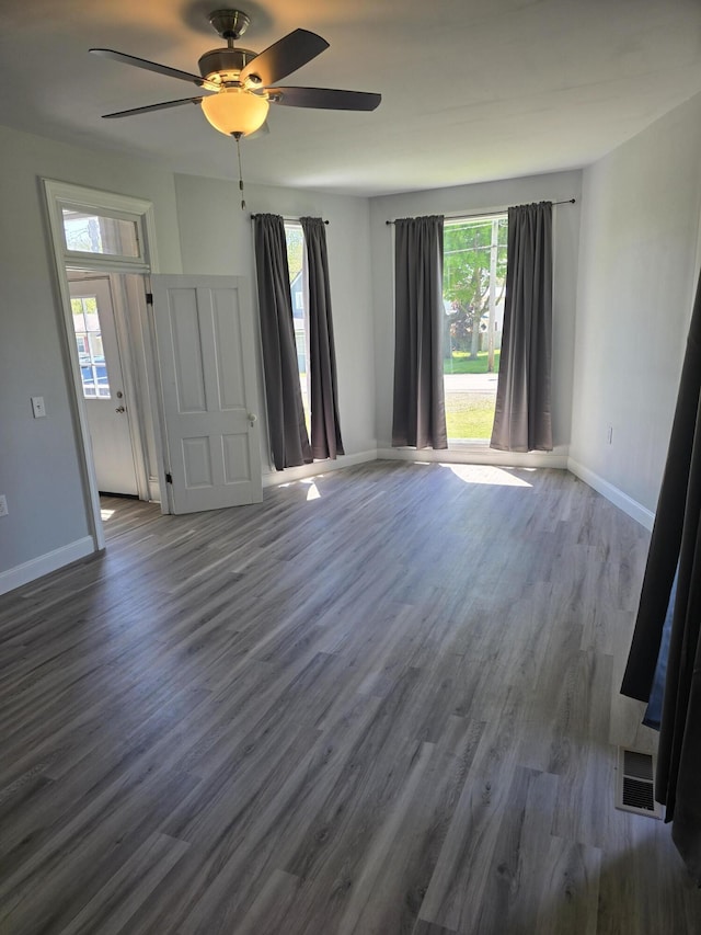 318 W Buckeye St, Belle Center, OH 43310 - empty room featuring dark wood finished floors, ceiling fan, and baseboards