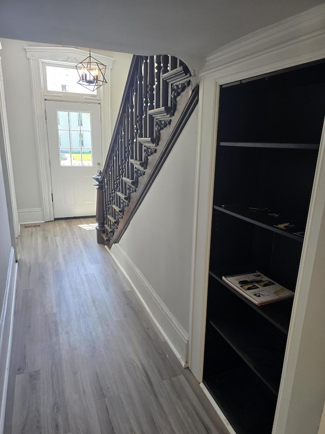 318 W Buckeye St, Belle Center, OH 43310 - entrance foyer with stairs, wood finished floors, baseboards, and a chandelier