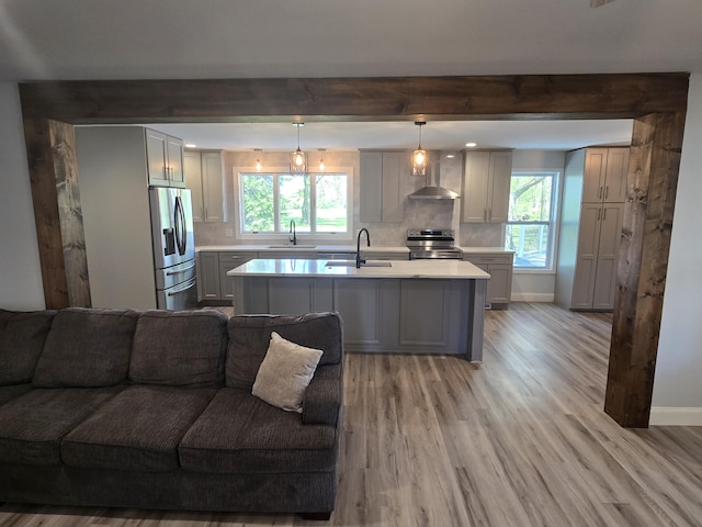 318 W Buckeye St, Belle Center, OH 43310 - kitchen with stainless steel appliances, open floor plan, wall chimney range hood, gray cabinets, and a sink
