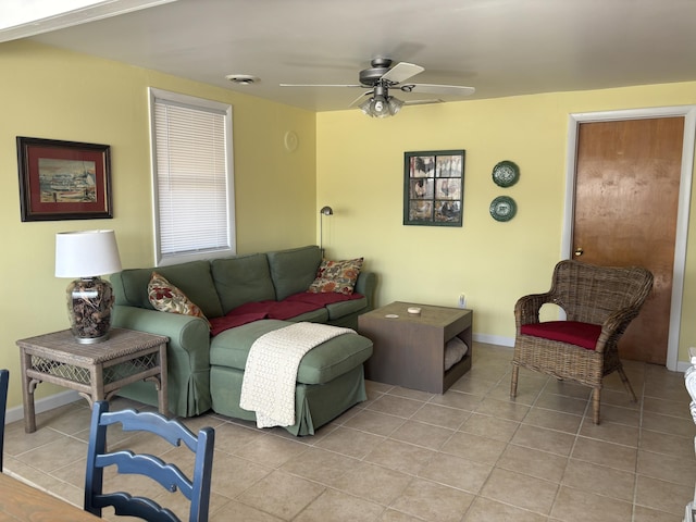 living area featuring visible vents, baseboards, light tile patterned flooring, and a ceiling fan