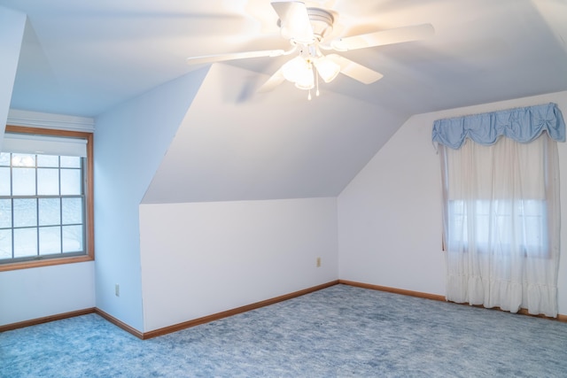 bonus room with baseboards, vaulted ceiling, and light colored carpet