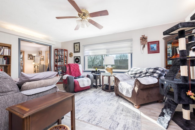 living room featuring ceiling fan and wood finished floors