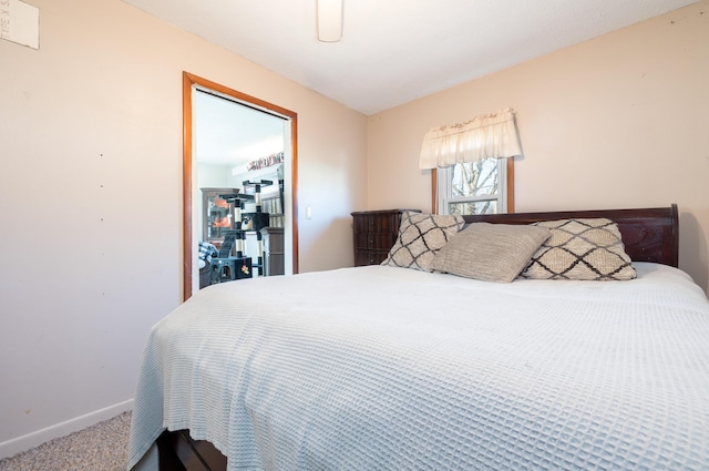 bedroom featuring baseboards and carpet flooring