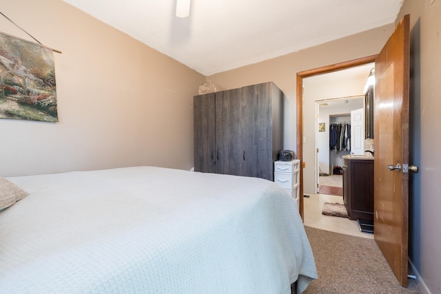 bedroom with light colored carpet and a ceiling fan