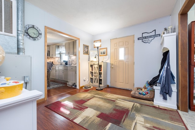 foyer entrance with wood finished floors and visible vents