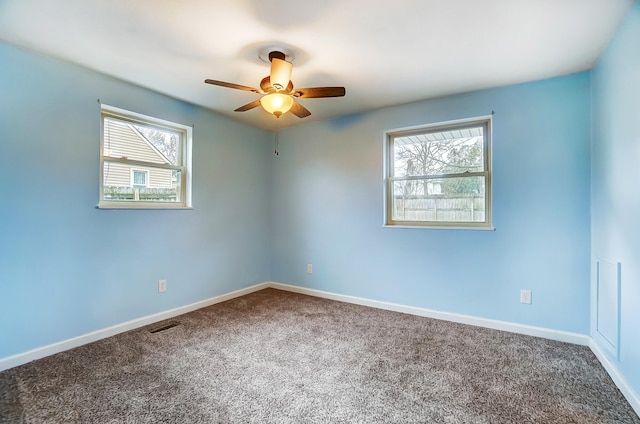 empty room with ceiling fan and carpet