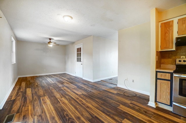 interior space featuring ceiling fan, dark hardwood / wood-style floors, and a textured ceiling