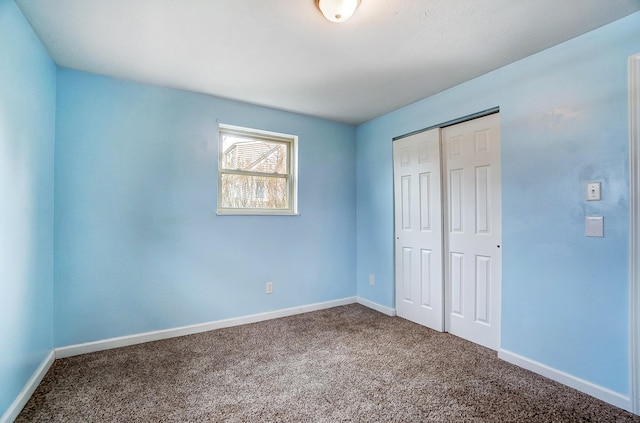 unfurnished bedroom featuring carpet flooring and a closet