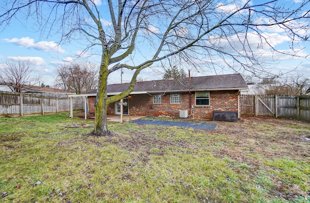 back of property with a patio, central AC unit, and a lawn