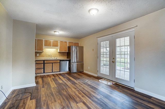 kitchen featuring french doors, sink, dark hardwood / wood-style floors, stainless steel appliances, and backsplash