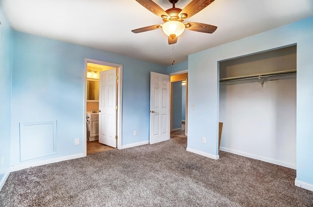 unfurnished bedroom with dark colored carpet, ensuite bathroom, ceiling fan, and a closet