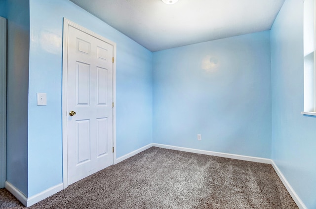 empty room with dark carpet