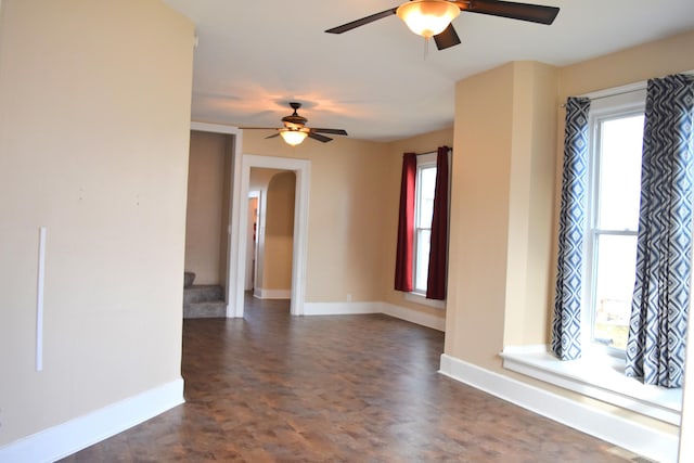 spare room with ceiling fan and a healthy amount of sunlight