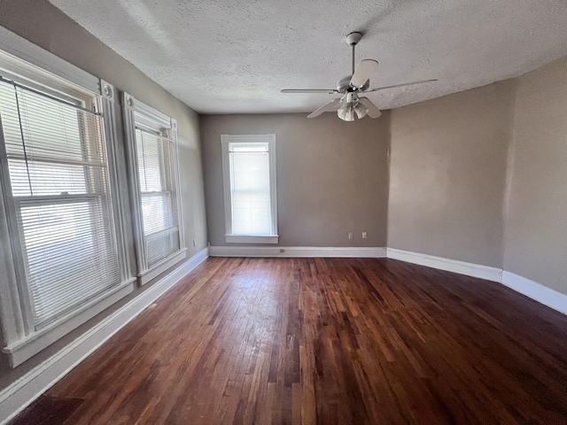 spare room with ceiling fan, a textured ceiling, baseboards, and wood finished floors