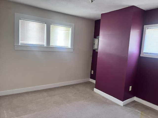 unfurnished room featuring carpet floors and baseboards