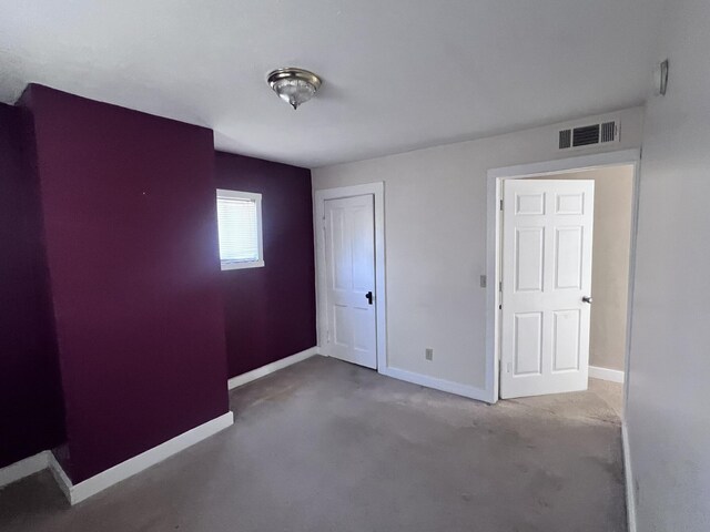 unfurnished bedroom featuring a closet, visible vents, and baseboards