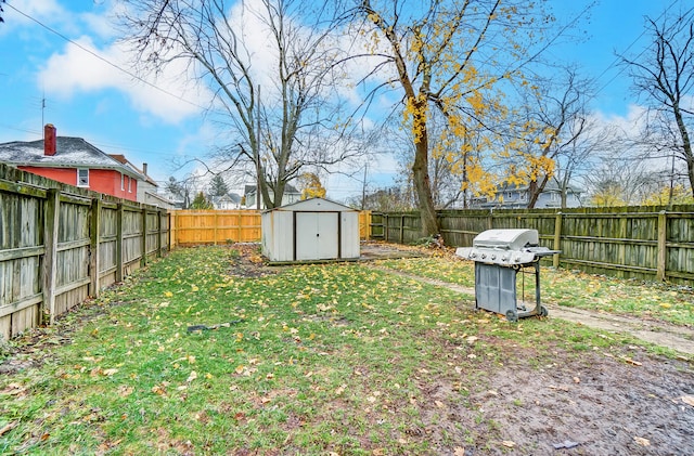 view of yard featuring a fenced backyard, an outdoor structure, and a storage shed