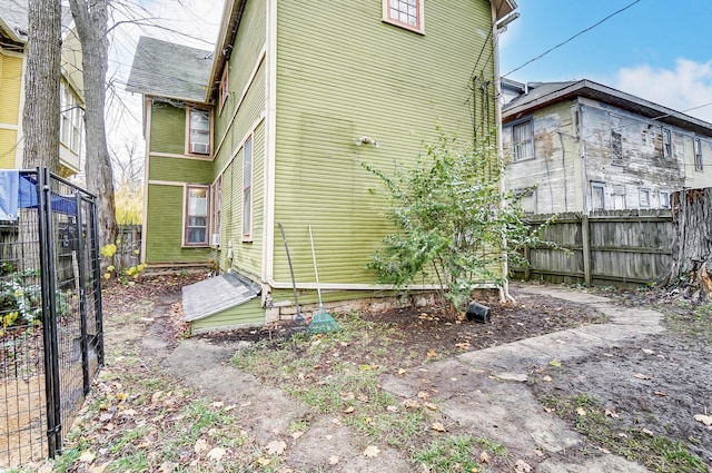 view of side of home with fence