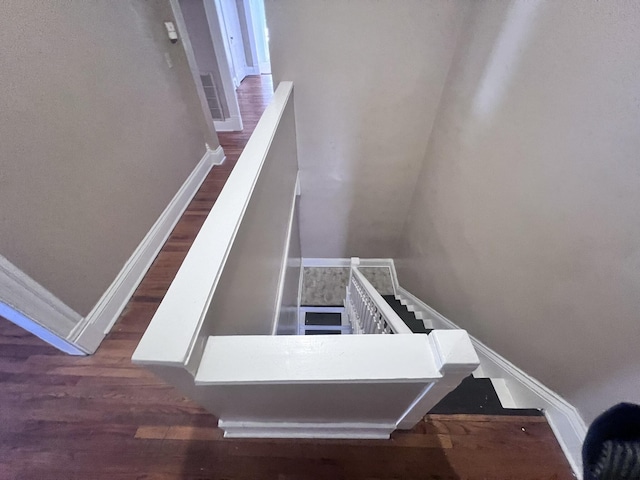 stairs featuring baseboards and wood finished floors