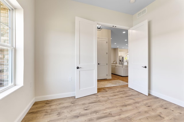 unfurnished bedroom featuring recessed lighting, baseboards, visible vents, and light wood finished floors