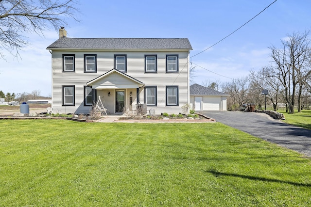 3420 Old Springfield Rd, London, OH 43140 - colonial-style house featuring a front lawn, a detached garage, roof with shingles, and a chimney