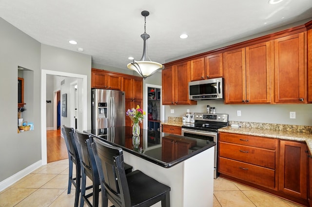 4114 Brookston Dr, Springfield, OH 45502 - kitchen featuring stainless steel appliances, light tile patterned floors, recessed lighting, hanging light fixtures, and a kitchen island