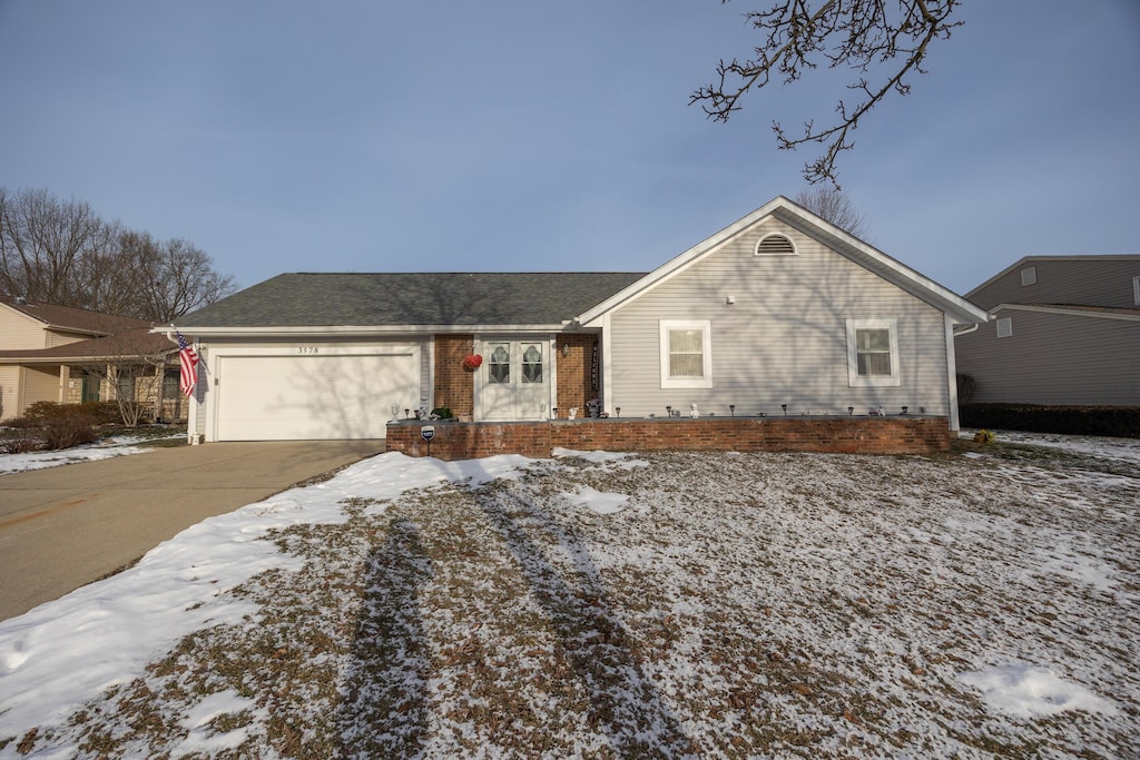 ranch-style home featuring a garage