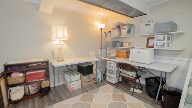 home office with crown molding and wood finished floors