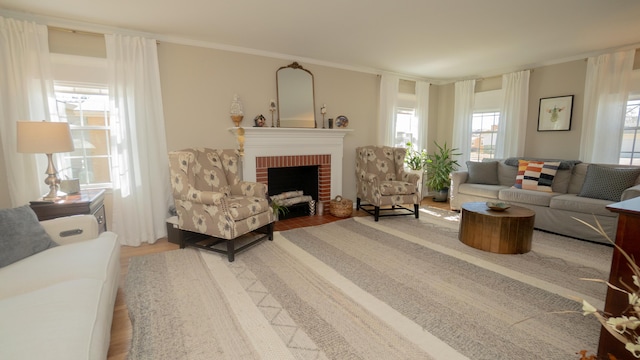 living area featuring a fireplace, wood finished floors, and ornamental molding