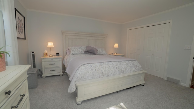 bedroom with crown molding, visible vents, a closet, and light carpet