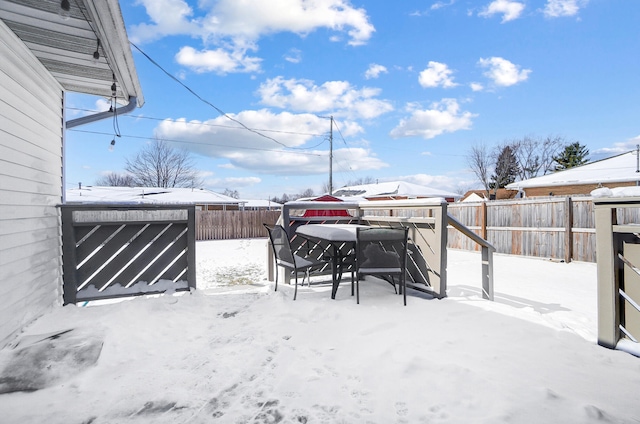 snowy yard with fence