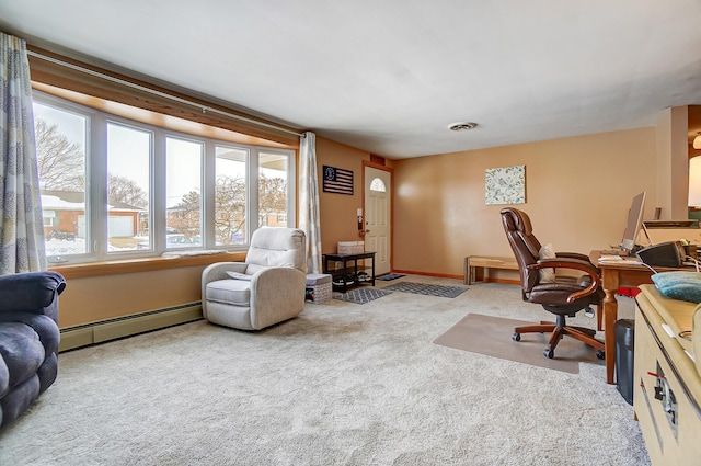 carpeted office space with a baseboard heating unit, visible vents, and baseboards