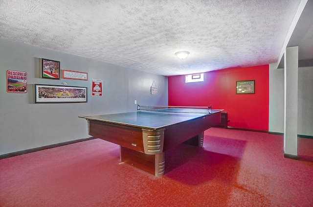 recreation room with a textured ceiling, carpet, and baseboards