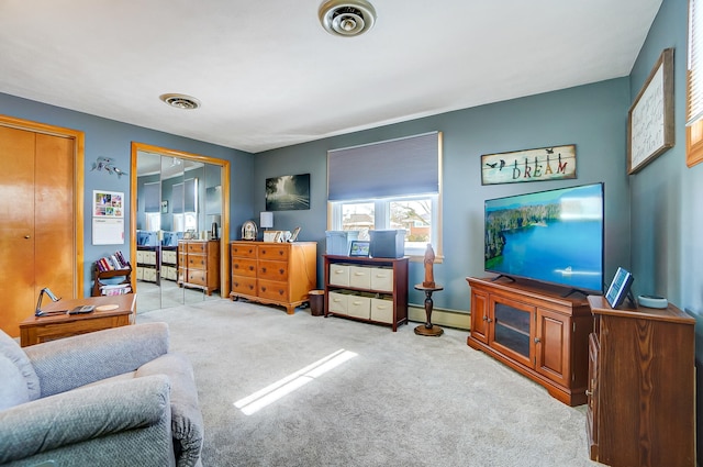 interior space featuring a baseboard heating unit, light carpet, and visible vents