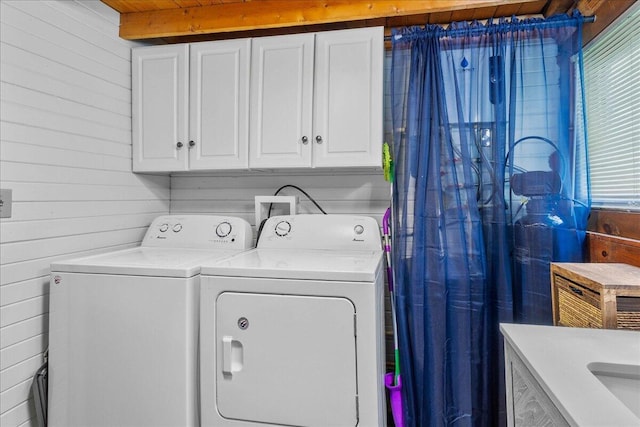 11350 Powhatan Path, Lakeview, OH 43331 - washroom featuring separate washer and dryer, cabinet space, and wood walls
