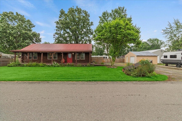11350 Powhatan Path, Lakeview, OH 43331 - log home featuring log exterior, a garage, a metal roof, and an outbuilding