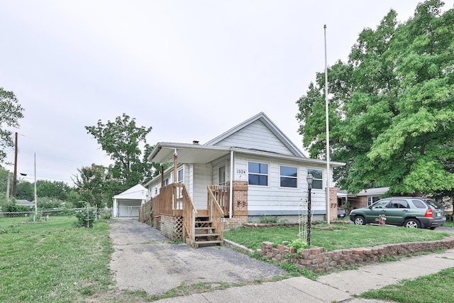 1024 Ansel Dr, Dayton, OH 45419 - view of front facade featuring an outbuilding, a detached garage, and covered porch