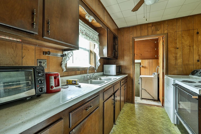 1024 Ansel Dr, Dayton, OH 45419 - kitchen with electric range, wood walls, light flooring, light countertops, and ceiling fan