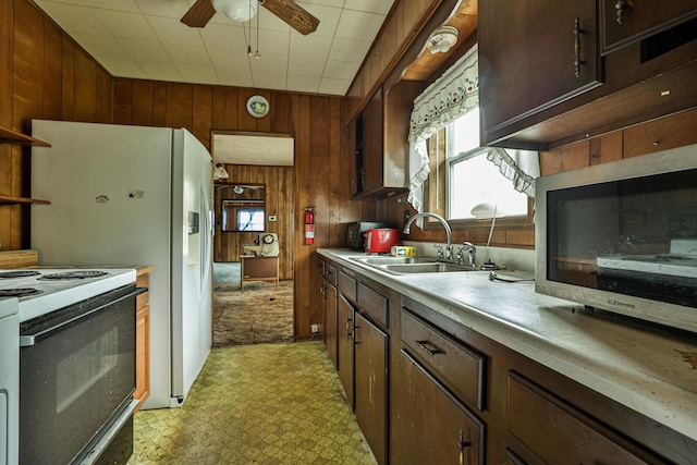 1024 Ansel Dr, Dayton, OH 45419 - kitchen with wooden walls, electric range, light flooring, light countertops, and a ceiling fan