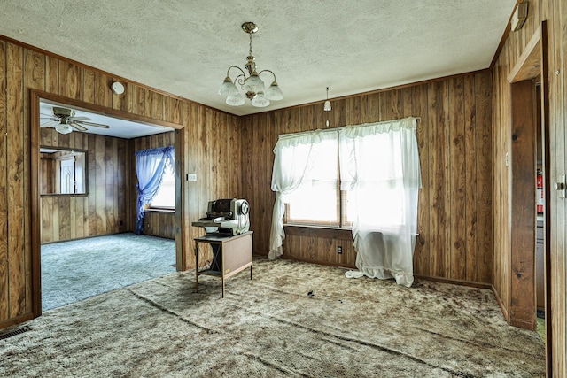 1024 Ansel Dr, Dayton, OH 45419 - carpeted home office featuring a chandelier, wood walls, a ceiling fan, and a textured ceiling