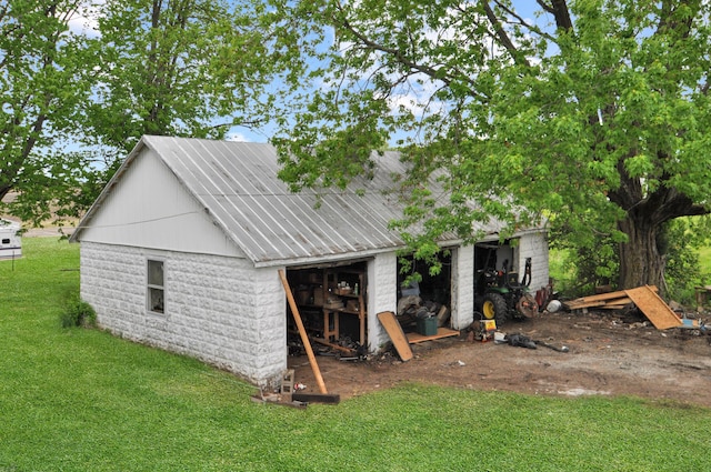 332 N Main St, New Madison, OH 45346 - rear view of property with a lawn and an outbuilding