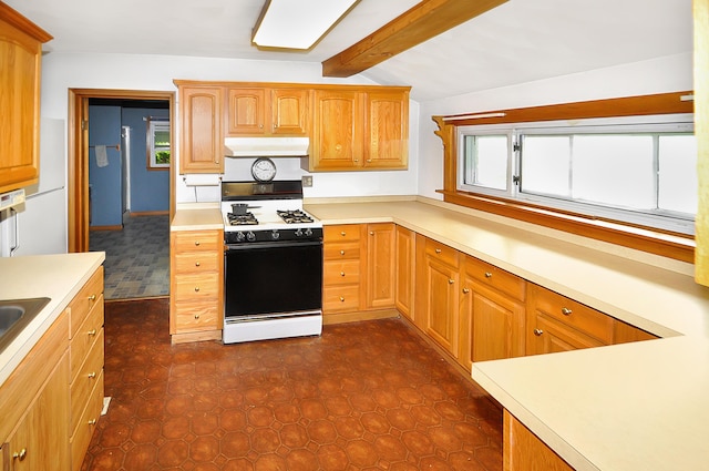 332 N Main St, New Madison, OH 45346 - kitchen featuring gas range, under cabinet range hood, light countertops, beamed ceiling, and dark flooring