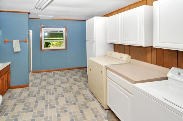 332 N Main St, New Madison, OH 45346 - laundry area featuring cabinet space, washing machine and clothes dryer, baseboards, and wooden walls
