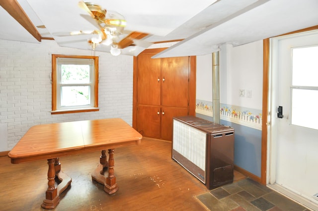 332 N Main St, New Madison, OH 45346 - kitchen featuring brick wall, wood finished floors, and baseboards
