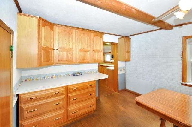 332 N Main St, New Madison, OH 45346 - kitchen featuring brick wall, dark wood-style flooring, light countertops, and beam ceiling