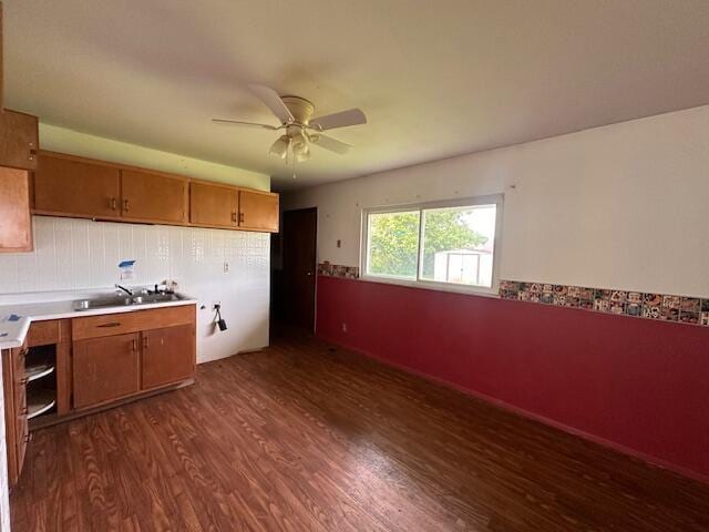 1432 Attleboro Ave, Springfield, OH 45503 - kitchen featuring dark wood-type flooring, ceiling fan, light countertops, brown cabinetry, and a wainscoted wall